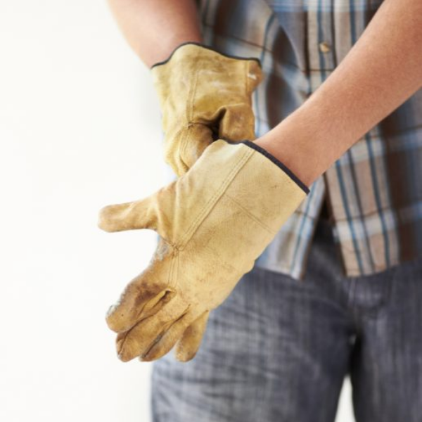 hand Safety | Hand Protection | Person holding helmet and gloves. 